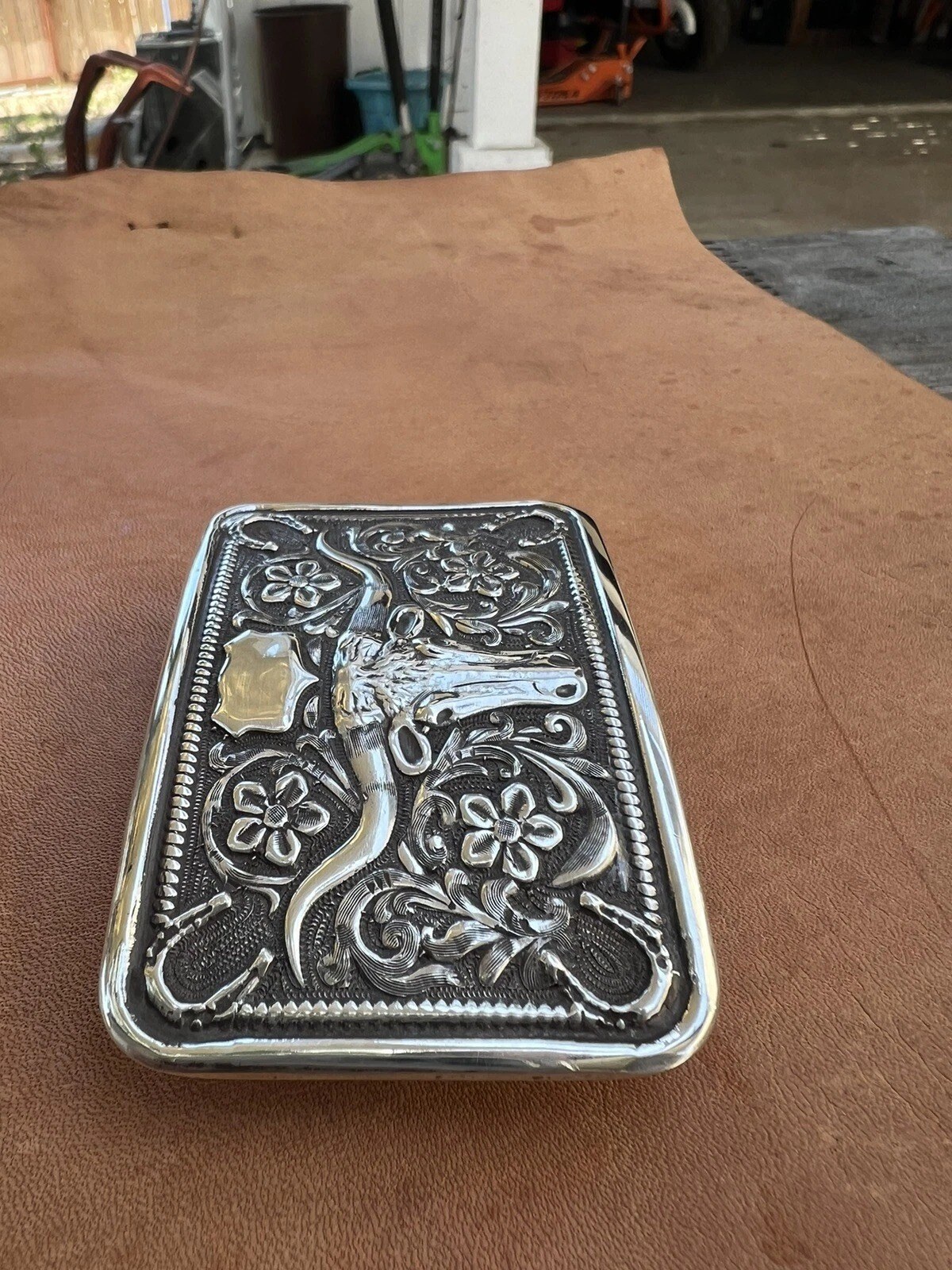 sterling silver steer head horseshoe trophy buckle, turned on its side