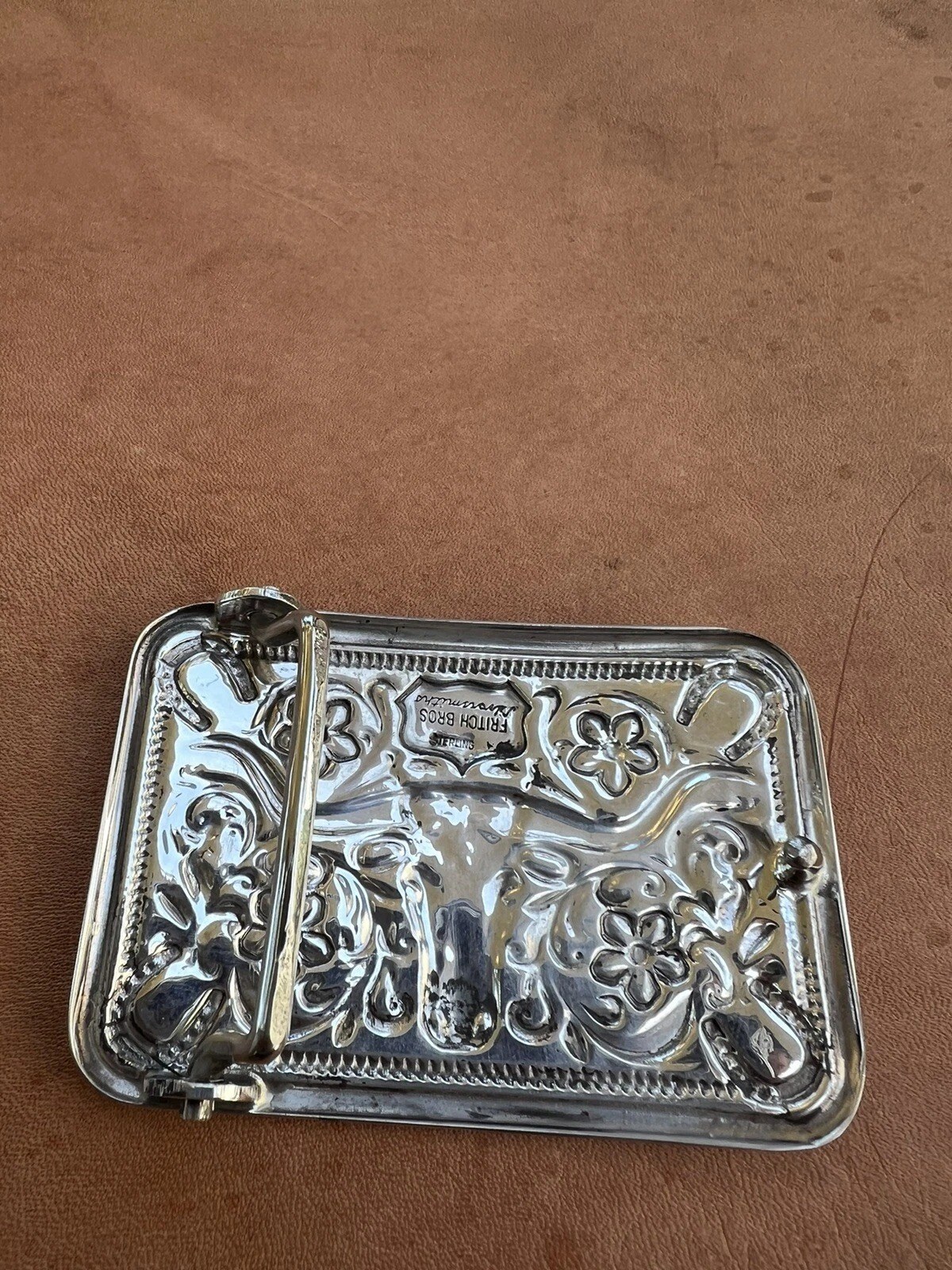 back of the sterling silver steer head horseshoe trophy buckle with the maker stamp and belt loop