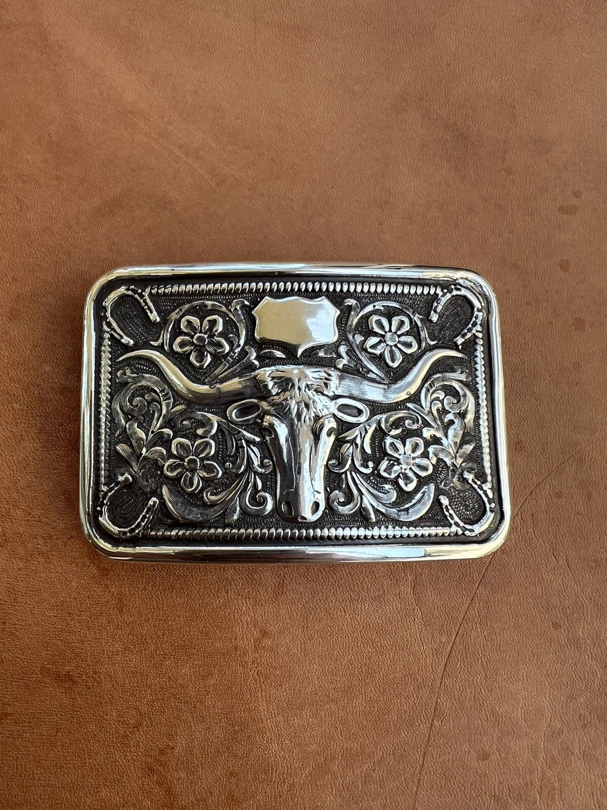 sterling silver steer head horseshoe trophy buckle on leather