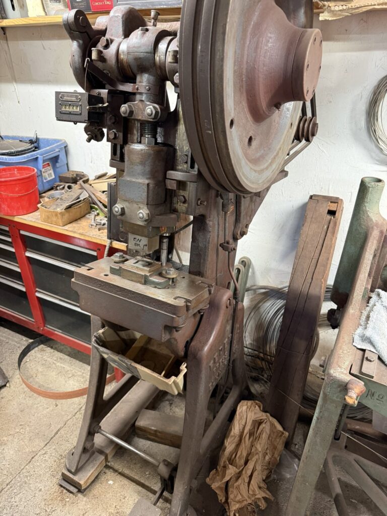 A vintage flywheel press in the Fritch Brothers workshop