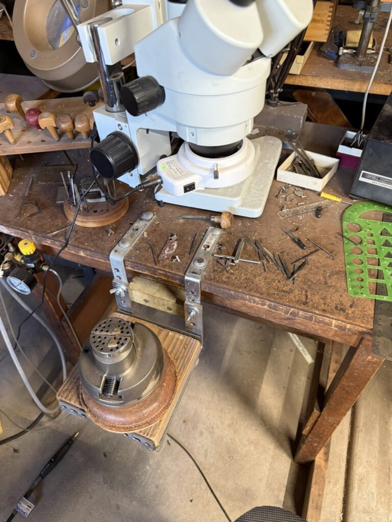 The engraving bench with a microscope and hand tools